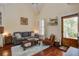 Charming living room featuring a comfortable couch, vaulted ceilings, and wooden floors, perfect for relaxing at 7759 Edingsville Beach Rd, Edisto Island, SC 29438
