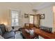 Bright and airy living area with a vaulted ceiling, hardwood floors, and a view through the glass paneled front door at 7759 Edingsville Beach Rd, Edisto Island, SC 29438