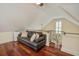 Comfortable loft area with a cozy couch, hardwood floors, and a bright window at 7759 Edingsville Beach Rd, Edisto Island, SC 29438