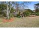 A wooden playground, nestled beneath a mature shade tree, perfect for outdoor fun and adventure at 7759 Edingsville Beach Rd, Edisto Island, SC 29438