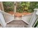Inviting porch stairs leading to outdoor seating amid lush greenery at 7759 Edingsville Beach Rd, Edisto Island, SC 29438