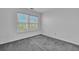 A clean, carpeted bedroom offers a bright, airy feel with natural light streaming in from a large window at 804 Buckthorn Cir, Summerville, SC 29483