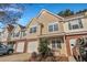 Charming townhouse boasts a brick-accented garage, cozy front porch, and well-maintained lawn, perfect for easy living at 804 Buckthorn Cir, Summerville, SC 29483