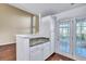 This kitchen has granite countertops, white cabinets, and access to an outdoor patio at 804 Buckthorn Cir, Summerville, SC 29483