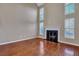 Bright living room featuring soaring ceilings, hardwood floors, a fireplace, and large windows at 804 Buckthorn Cir, Summerville, SC 29483