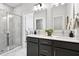 Modern bathroom with double sinks, gray cabinetry, a large mirror, and a glass-enclosed shower at 808 Alma Square Dr, Moncks Corner, SC 29461