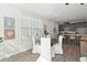 Bright dining area featuring a modern kitchen, a round wood table, and large windows at 808 Alma Square Dr, Moncks Corner, SC 29461