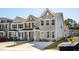 A row of charming two-story townhomes with landscaped yards and concrete driveways at 808 Alma Square Dr, Moncks Corner, SC 29461