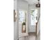Hallway with a console table and a view into a brightly lit room with blinds at 808 Alma Square Dr, Moncks Corner, SC 29461