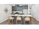 Stylish kitchen featuring gray cabinets, stainless steel appliances, a subway tile backsplash, and an island with bar seating at 808 Alma Square Dr, Moncks Corner, SC 29461
