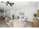 Open-concept living room with hardwood floors, stylish furniture, and plenty of natural light at 808 Alma Square Dr, Moncks Corner, SC 29461