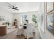 A modern living room featuring a ceiling fan, a round wood table, and large windows at 808 Alma Square Dr, Moncks Corner, SC 29461