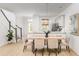 Bright dining area with modern lighting, stylish chairs, and an open view into the adjacent kitchen and staircase at 810 Alma Square Dr, Moncks Corner, SC 29461