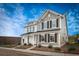 Charming townhome exterior showcasing a mix of gray and white siding, complemented by black shutters and a well-manicured front yard at 810 Alma Square Dr, Moncks Corner, SC 29461
