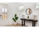 Bright foyer featuring a decorative table, round mirror, stylish lamps, and a lush potted plant adding a touch of nature at 810 Alma Square Dr, Moncks Corner, SC 29461