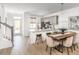 Open-concept kitchen and dining area with modern lighting, stainless steel appliances, and a convenient breakfast bar at 810 Alma Square Dr, Moncks Corner, SC 29461