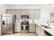 Stylish kitchen featuring stainless steel appliances, gray cabinets, quartz countertops, and a subway tile backsplash at 810 Alma Square Dr, Moncks Corner, SC 29461