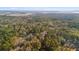 Expansive aerial view showcasing the property's lush surroundings and the distant waterways at 8255 Chisolm Plantation Rd, Edisto Island, SC 29438