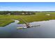 Aerial view of a dock with gazebo and a boat in a marsh waterfront community at 8255 Chisolm Plantation Rd, Edisto Island, SC 29438