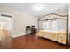 Bedroom with hardwood floors and large bed, well-lit and large window at 8255 Chisolm Plantation Rd, Edisto Island, SC 29438