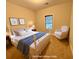 This virtually staged bedroom has two decor paintings, a bed, and an armchair at 8255 Chisolm Plantation Rd, Edisto Island, SC 29438