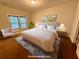 Staged bedroom with hardwood floors, large bed, bedside tables, and lots of light at 8255 Chisolm Plantation Rd, Edisto Island, SC 29438