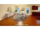 This virtually staged dining room features hardwood floors, a round dining table and neutral decor at 8255 Chisolm Plantation Rd, Edisto Island, SC 29438