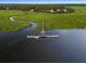 Stunning aerial view of a private dock, gazebo, and boat slip extending into the tranquil waterway at 8255 Chisolm Plantation Rd, Edisto Island, SC 29438