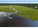 Aerial view of the dock with a gazebo extending into the waterway, surrounded by lush marshlands at 8255 Chisolm Plantation Rd, Edisto Island, SC 29438