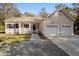 Charming home features a covered front porch and a convenient two-car attached garage at 8255 Chisolm Plantation Rd, Edisto Island, SC 29438