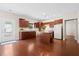 Well-lit kitchen with wood cabinets, granite countertops, stainless steel appliances, and hardwood floors at 8255 Chisolm Plantation Rd, Edisto Island, SC 29438