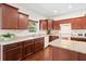 Well-lit kitchen with wooden cabinets, granite countertops, stainless steel sink, and modern appliances at 8255 Chisolm Plantation Rd, Edisto Island, SC 29438