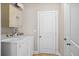 A functional laundry room with side by side washer and dryer at 8255 Chisolm Plantation Rd, Edisto Island, SC 29438
