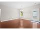 Minimalist space with hardwood floors, and a large door leading to a backyard at 8255 Chisolm Plantation Rd, Edisto Island, SC 29438