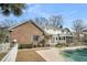 Beautiful brick and siding home with a refreshing swimming pool, lawn, and partial fence at 8615 Arthur Hills Cir, North Charleston, SC 29420