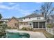 Exterior backyard featuring brick and vinyl siding, an enclosed porch, and a pool at 8615 Arthur Hills Cir, North Charleston, SC 29420