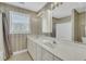 Spacious bathroom boasts double sinks, ample counter space, a large mirror and a bathtub-shower combo at 8615 Arthur Hills Cir, North Charleston, SC 29420
