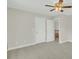 An empty bedroom with neutral colored walls and carpet and a ceiling fan at 8615 Arthur Hills Cir, North Charleston, SC 29420