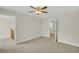 An empty bedroom with neutral colored walls and carpet and a ceiling fan at 8615 Arthur Hills Cir, North Charleston, SC 29420