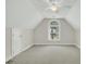 A bright bedroom with neutral carpet and walls has a large arch window, white trim, and white ceiling fan at 8615 Arthur Hills Cir, North Charleston, SC 29420