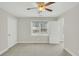 An empty bedroom with neutral colored walls and carpet and a ceiling fan at 8615 Arthur Hills Cir, North Charleston, SC 29420