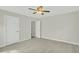An empty bedroom with neutral colored walls and carpet and a ceiling fan at 8615 Arthur Hills Cir, North Charleston, SC 29420