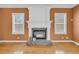 Living room fireplace featuring a brick hearth, a white mantle, and natural light from adjacent windows at 8615 Arthur Hills Cir, North Charleston, SC 29420