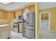 Modern kitchen with stainless steel appliances, wood cabinets, and a door leading to the laundry room at 8615 Arthur Hills Cir, North Charleston, SC 29420