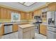 Bright kitchen featuring stainless steel appliances, wood cabinets, and a center island with white tile floors at 8615 Arthur Hills Cir, North Charleston, SC 29420