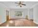 Bright living room featuring hardwood floors, a ceiling fan, and an exterior door at 8615 Arthur Hills Cir, North Charleston, SC 29420