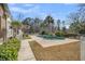 Backyard featuring a pool, mature trees, and well-maintained landscaping at 8615 Arthur Hills Cir, North Charleston, SC 29420