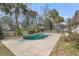 Backyard featuring a kidney-shaped pool, lush landscaping, and a privacy fence at 8615 Arthur Hills Cir, North Charleston, SC 29420