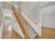 Inviting staircase with wood railing and carpeted steps at 8615 Arthur Hills Cir, North Charleston, SC 29420