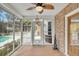Enclosed sunroom showcasing screened windows, a ceiling fan, and pool views at 8615 Arthur Hills Cir, North Charleston, SC 29420
